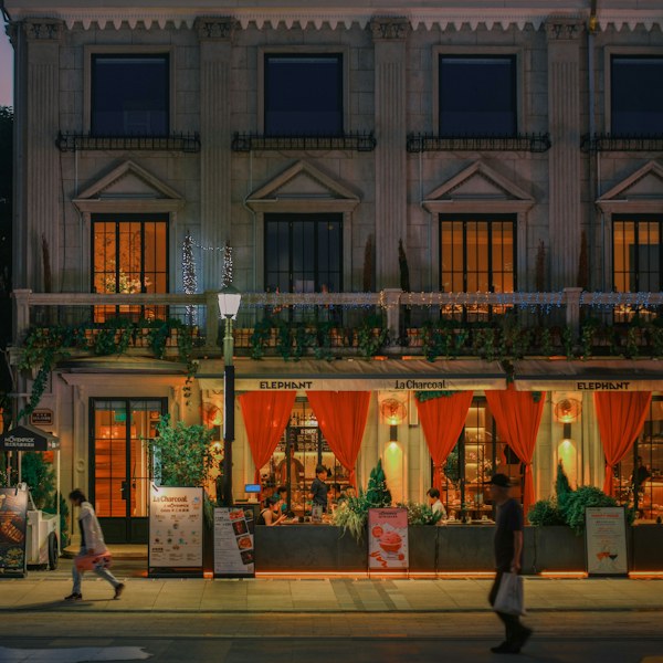 Restaurant storefront lit up at dusk
